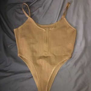 Beige, thong, zip up bodysuit.